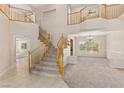 Bright, open foyer with staircase, large windows, and elegant chandelier for a grand entrance at 6013 Jubilee Gardens Ave, Las Vegas, NV 89131