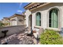 Inviting front porch featuring textured walls, comfortable seating, and picturesque garden views at 606 Cadence Vista Dr, Henderson, NV 89011