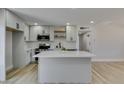 Modern kitchen featuring white cabinets, stainless steel appliances and an island at 6100 Fawn Cir, Las Vegas, NV 89107