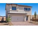 Charming two-story home with a two car garage, paver driveway, and minimal landscaping at 6787 Magnolia River Ave, Las Vegas, NV 89156