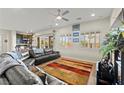 Bright living room with large windows, plantation shutters, and an open floor plan at 6980 W Meranto Ave, Las Vegas, NV 89178
