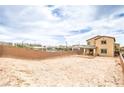 Expansive backyard view with a block wall, potential pool, and houses in the distance at 7045 Judith River St, North Las Vegas, NV 89084