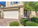 Charming two-story home with a well-manicured front yard and a two-car garage at 7045 Judith River St, North Las Vegas, NV 89084