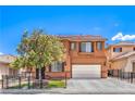 Inviting two-story home with a well-kept front yard, charming tree, and a convenient two-car garage at 7959 Palace Monaco Ave, Las Vegas, NV 89117