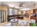 Spacious living room featuring tile floors, a ceiling fan, ample seating, and an open floorplan at 7959 Palace Monaco Ave, Las Vegas, NV 89117