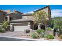 Charming home with a two-car garage, desert landscaping, and a welcoming front entrance in a residential area at 8 Via Dolcetto, Henderson, NV 89011