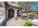 Inviting front porch with stone accents and comfortable seating, creating a warm and welcoming entry at 8 Via Dolcetto, Henderson, NV 89011