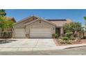 Inviting single-story home features a two-car garage, desert landscaping, and a neutral color palette at 8777 Shady Peak Way, Las Vegas, NV 89123