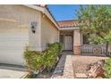 Welcoming front entrance with a brick walkway, desert landscaping, and a charming entryway at 8777 Shady Peak Way, Las Vegas, NV 89123