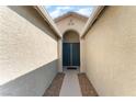 Inviting entrance with double doors and attractive archway, creating a welcoming ambiance at 908 Cypress Gold Ct, North Las Vegas, NV 89031