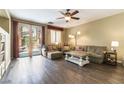 Bright living room featuring wood-look floors, comfortable seating, and backyard access at 922 Lloyd George Dr, Henderson, NV 89052