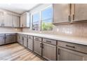 Modern kitchen with gray cabinets, sleek countertops, and stainless steel appliances at 9314 Observatory St, Las Vegas, NV 89143