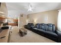 Spacious living room with plush seating and a view of the eat-in kitchen at 9393 New Utrecht St, Las Vegas, NV 89178