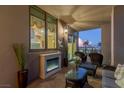 Inviting balcony with a fireplace, seating area, and city views, perfect for enjoying the outdoors at 1 Hughes Center Dr # 308, Las Vegas, NV 89169