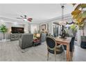 Bright living room featuring contemporary decor, ceiling fan, and access to the outdoor patio at 10484 Rose Park Ave, Las Vegas, NV 89135