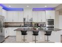 Contemporary kitchen featuring white cabinets, granite countertops, and a large island at 1073 Via Della Costrella, Las Vegas, NV 89101