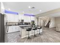 Modern kitchen with white cabinets, stainless steel appliances, and granite countertops at 1073 Via Della Costrella, Las Vegas, NV 89101