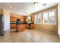 Well-lit kitchen boasts stainless steel appliances, wood cabinets, granite countertops, and a tile backsplash at 11238 Meadow Cove St, Las Vegas, NV 89179