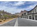 New home street with mountain views offering modern townhome living and community amenities at 11394 Crimson Ledge Ave, Las Vegas, NV 89138