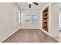 Bright bedroom features wood floors, built-in shelving, and plantation shutters for ample natural light at 1155 Phillip Island St, Henderson, NV 89052