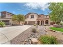 Beautiful two-story home boasts a three-car garage, stone accents, desert landscaping and mature trees at 1155 Phillip Island St, Henderson, NV 89052