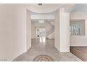Open foyer with tile flooring, grand staircase and light-filled living spaces creating a welcoming atmosphere at 1155 Phillip Island St, Henderson, NV 89052