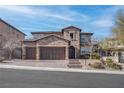 Charming two-story house with a stone-accented facade, complemented by a spacious three-car garage at 11952 Girasole Ave, Las Vegas, NV 89138