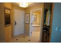 Hallway with a guest bathroom, art and entry door at 145 E Harmon Ave # 27619, Las Vegas, NV 89109