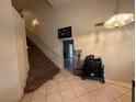 Bright foyer with tile flooring, staircase, and decorative chandelier at 1749 Green Apple Way, Las Vegas, NV 89142