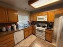 Traditional kitchen with tile backsplash, granite countertops, and white appliances at 1749 Green Apple Way, Las Vegas, NV 89142