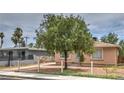 Street view of a single story home with mature trees in front yard at 240 N 19Th St, Las Vegas, NV 89101