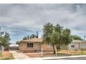 Single story home with small front yard and a fenced drive way at 240 N 19Th St, Las Vegas, NV 89101