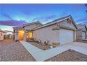 Inviting single-story home with a well-maintained facade, desert landscaping, and an attached two-car garage at 2595 Amber Crest St, Las Vegas, NV 89142