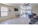 Bright living room with large windows and a decorative fireplace at 2595 Amber Crest St, Las Vegas, NV 89142