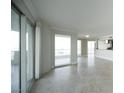 Spacious living room featuring tile floors, large windows, and access to a balcony at 2777 Paradise Rd # 1505, Las Vegas, NV 89109