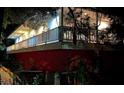 The exterior of the home has a second-floor balcony and is illuminated by the night sky and exterior lighting at 2855 Rice St, Logandale, NV 89021