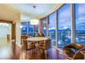 Contemporary dining room with a round table, city views, and stylish decor, complemented by hardwood floors at 322 Karen Ave # 2807, Las Vegas, NV 89109