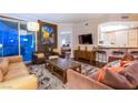 Open-concept living space with plush sofas, a large rug, and a glimpse of the kitchen, illuminated by city views at 322 Karen Ave # 2807, Las Vegas, NV 89109