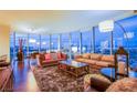 Spacious living room with city views, comfortable seating, a shag rug, and modern lighting fixtures at 322 Karen Ave # 2807, Las Vegas, NV 89109