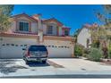 Charming two-story home with a red-tile roof, lush landscaping, and spacious driveway at 4487 Tomer Ln, Las Vegas, NV 89121