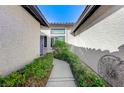 Inviting walkway leading to the front door with well-maintained landscaping on either side at 450 Intrepid Ct, Boulder City, NV 89005