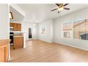 Bright living room with wood floors, ceiling fan, and natural light streaming through windows at 4655 Gold Dust Ave # 210, Las Vegas, NV 89120