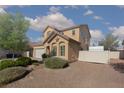 View of the house, with a decorative star, desert landscaping, and a painted fence at 5229 Giallo Vista Ct, North Las Vegas, NV 89031