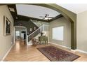 Inviting living room showcasing wood laminate floors and an open staircase with white banisters at 5229 Giallo Vista Ct, North Las Vegas, NV 89031