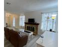 Bright living room featuring a fireplace and windows with decorative curtains at 5576 W Rochelle Ave # 12A, Las Vegas, NV 89103