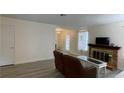 Open-concept living room with fireplace and hard surface flooring at 5576 W Rochelle Ave # 12A, Las Vegas, NV 89103