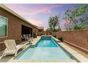 Backyard oasis featuring a sparkling pool, a spa, and ample seating for relaxation at 5616 Silver Cascade Ave, Las Vegas, NV 89131