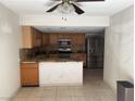 Functional kitchen with stainless steel appliances, granite countertops, and wooden cabinets at 6521 Sugarpine Ln, Las Vegas, NV 89107