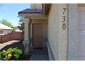 Beige front entrance and door with bushes and landscaping next to the covered entryway at 730 Goshawk St, Henderson, NV 89015