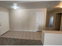 Inviting living room featuring tile flooring, neutral walls, and a view of the hallway and a second entry door at 732 Goshawk St, Henderson, NV 89015